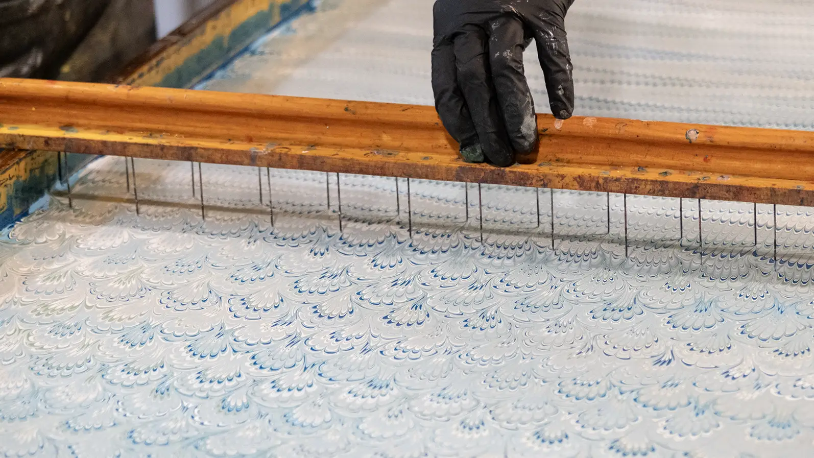 Brittani Locke of Soft Asylum creating a peacock marbling pattern